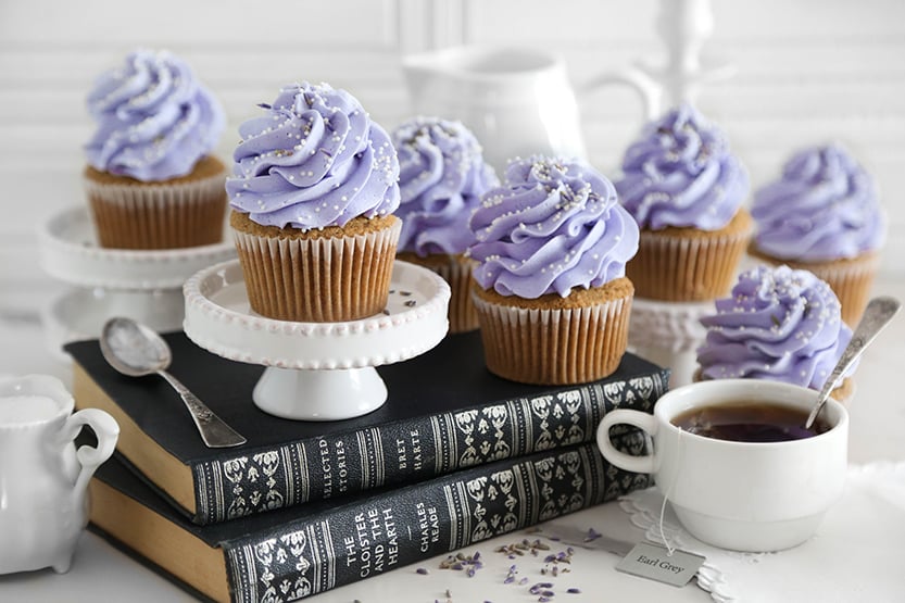 Lavender London Fog cupcakes with purple buttercream and lavender garnish on books